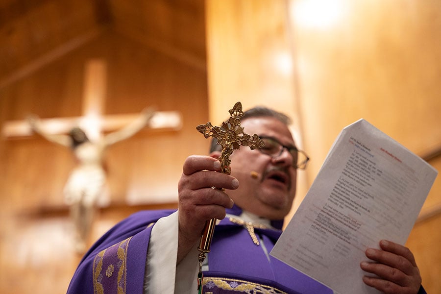 Fr. Assaad ElBasha conducts a blessing as he prepares ash for distribution during an Ash Monday Mass at Our Lady of Lebanon Maronite Catholic Church in Lewisville.