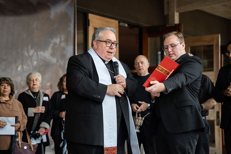 Isaac McCracken holds the bible for Bishop Olson