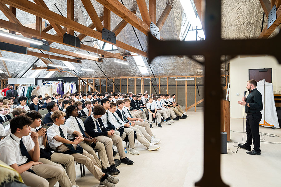 Father Brett Metzler speaks with large group of boys