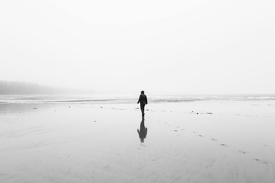 person at a distance walking on a beach