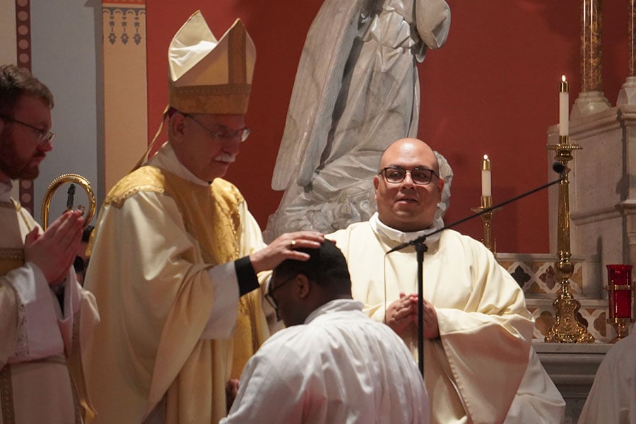 bishop lays hands on ordinand's head
