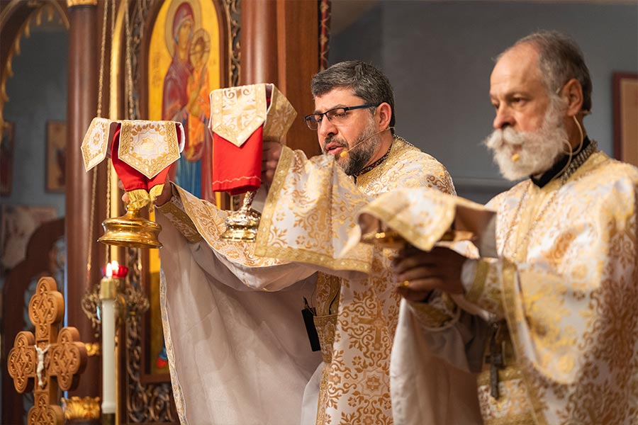 Rev. Pavlo Popov, left, and Rev. Frank Avant during the prayer of consecration at St. Sophia Ukrainian Greek Catholic Church in The Colony in March 6, 2022.