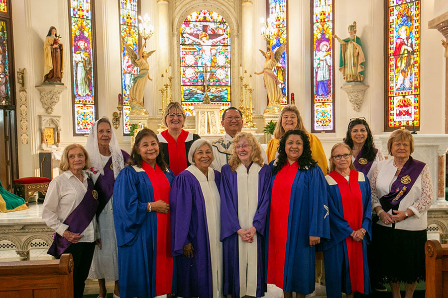 women and Fr. Hoa Nguyen at altar of St. Patrick Cathedral