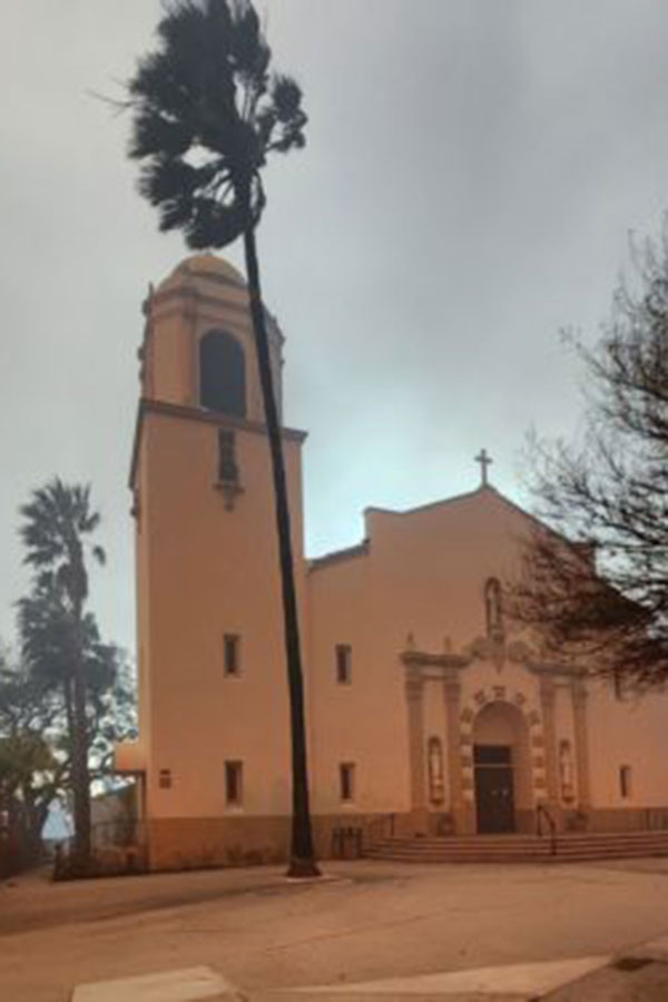 mission style church with smoke in background