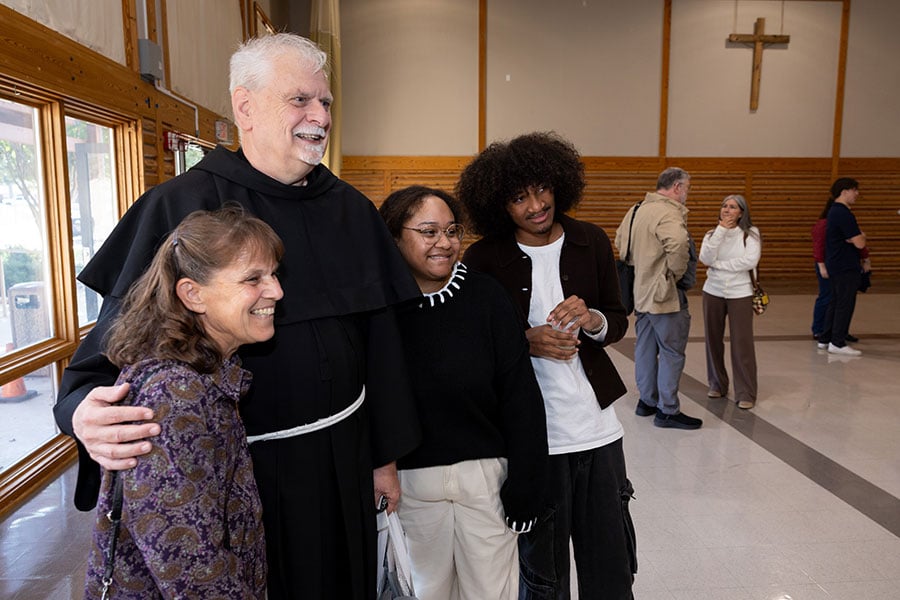 Father Ciski hugs parishioners