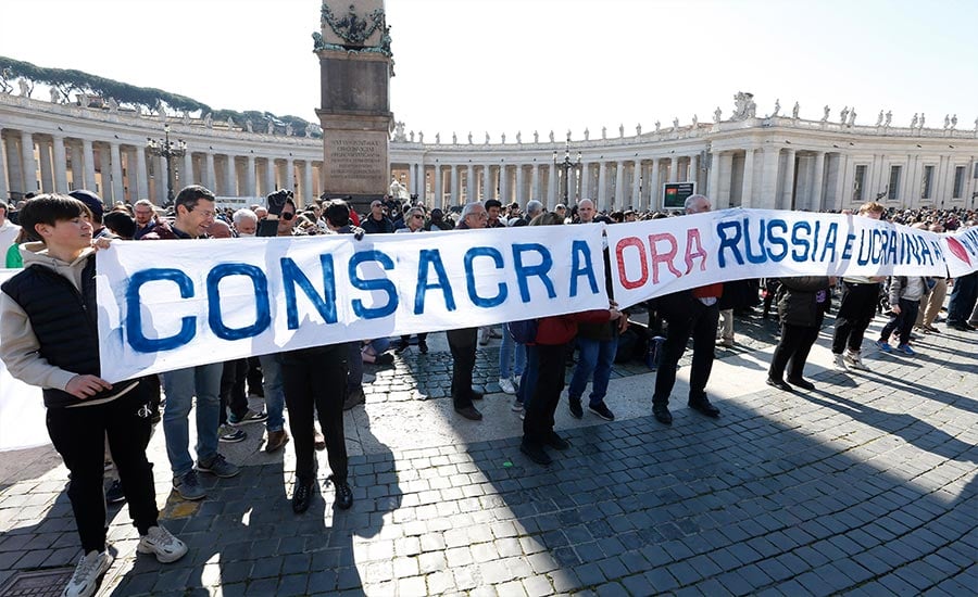 A sign in St. Peter's Square calls for the consecration of Russia and Ukraine to Mary, before the start of Pope Francis' Angelus at the Vatican March 13, 2022. The Vatican said Pope Francis will consecrate Russia and Ukraine to the Immaculate Heart of Mary March 25.