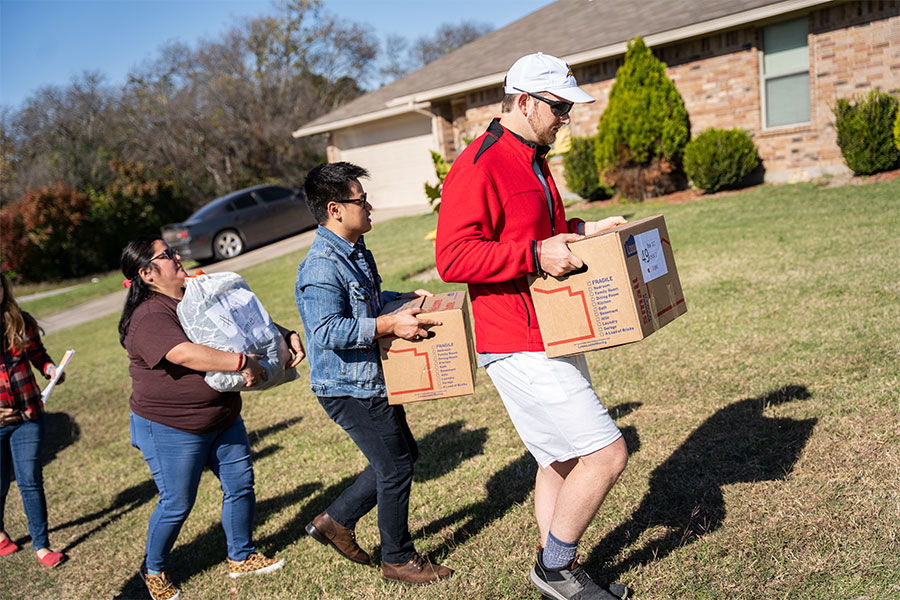 Young adults deliver Thanksgiving food to a needy family on Nov. 20 in Fort Worth.