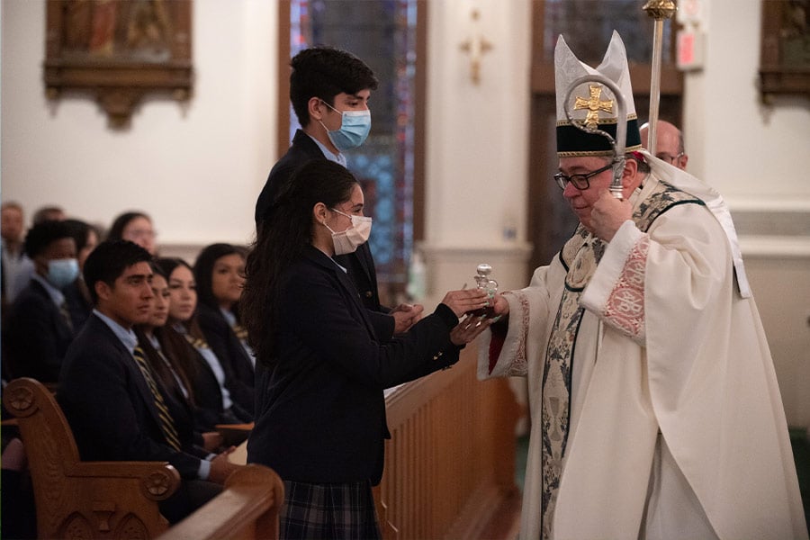 Bishop Michael Olson receives the Eucharistic items from Amy Arteaga and Juan Jasso during the Baccalaureate Mass for the graduating Class of 2022 from Cristo Rey Fort Worth, on June 03, 2022 at St. Patrick Cathedral Church in downtown Fort Worth. (NTC/Ben Torres)