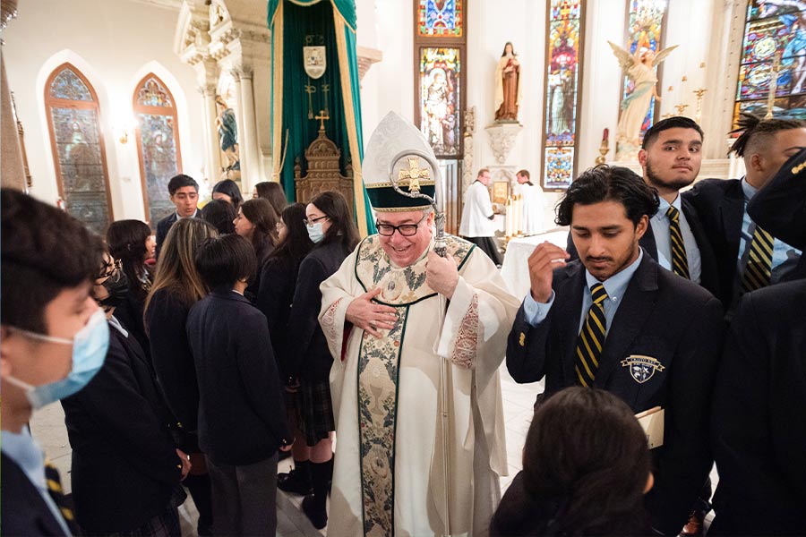 Bishop Michael Olson speaks with graduates as they prepare for a group photo after the Baccalaureate Mass for the graduating Class of 2022 from Cristo Rey Fort Worth, on June 03, 2022 at St. Patrick Cathedral Church in downtown Fort Worth. (NTC/Ben Torres)