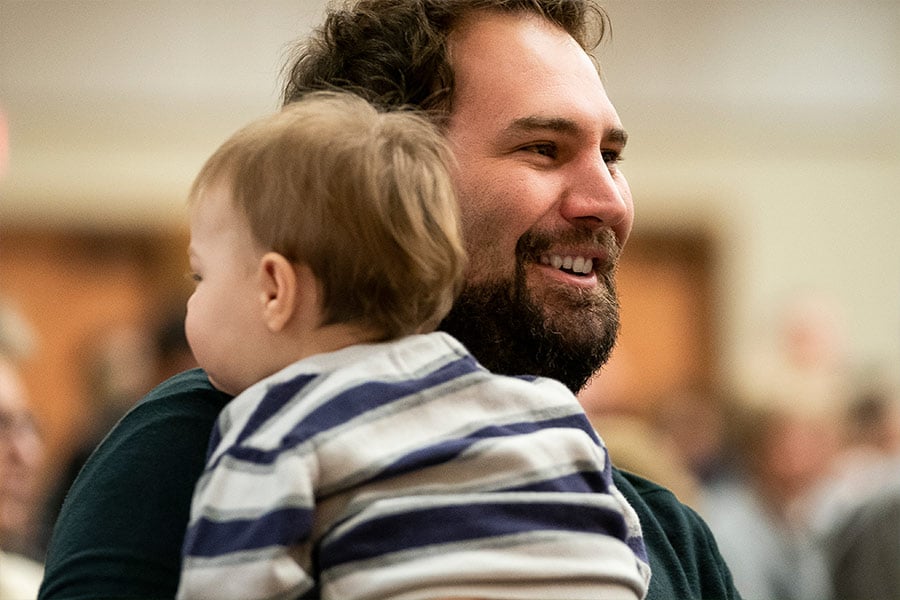 Parishioner Brad Horn holds his 1-year-old son during the annual Respect Life Mass on January 24, 2022 at St. Mark Parish in Arygle.