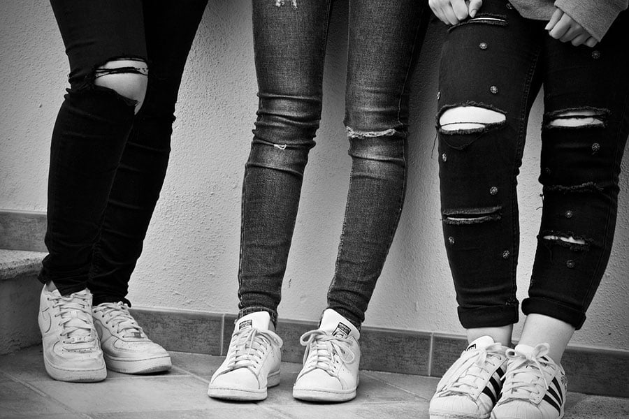 legs of girls wearing jeans