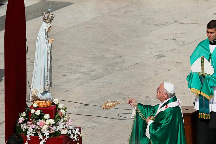 Pope Francis uses incense as he venerates the original statue of Our Lady of Fatima during a Mass at which he consecrated the world to Mary, in St. Peter's Square at the Vatican in this Oct. 13, 2013, file photo. The pope has invited the bishops of the world to join him in "consecrating and entrusting" Russia and Ukraine to Mary March 25.