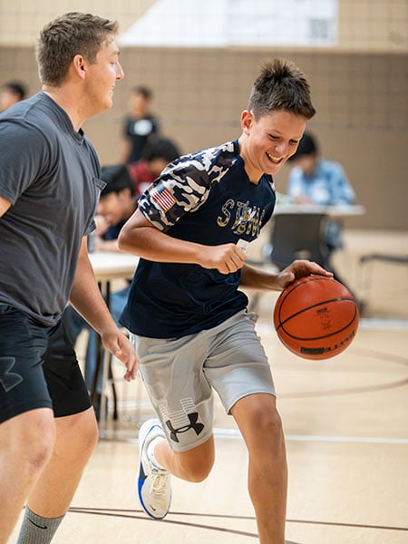 two men play basketball