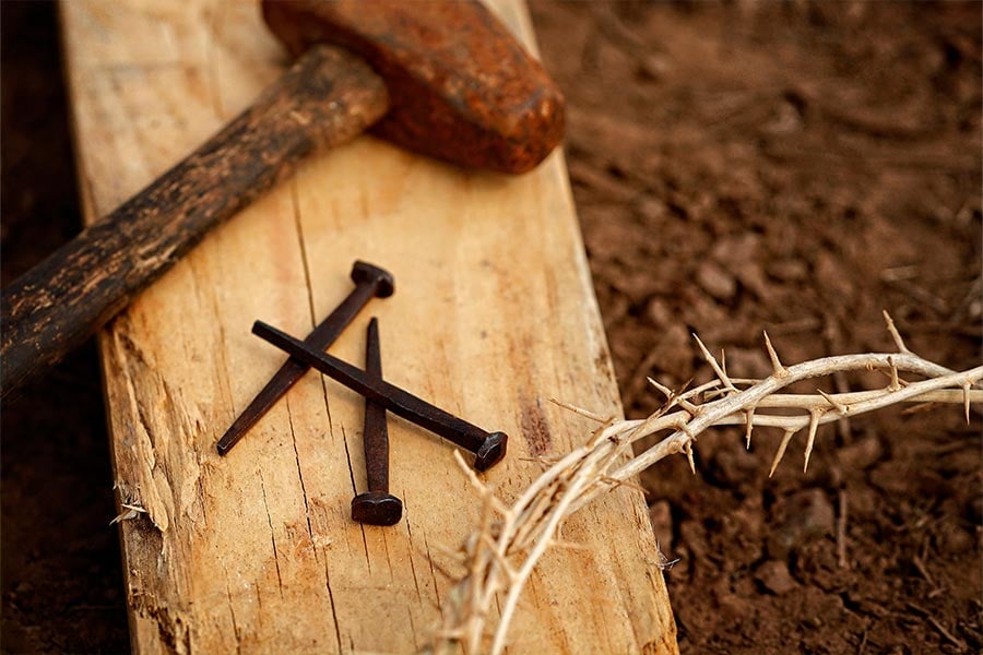 This is a Good Friday illustration photo of a hammer, nails, wood and a crown of thorns. In the passion narrative, we hear of the agony in the garden, the arrest and trial of Jesus, and his scourging and crucifixion. (CNS photo/Nancy Wiechec)