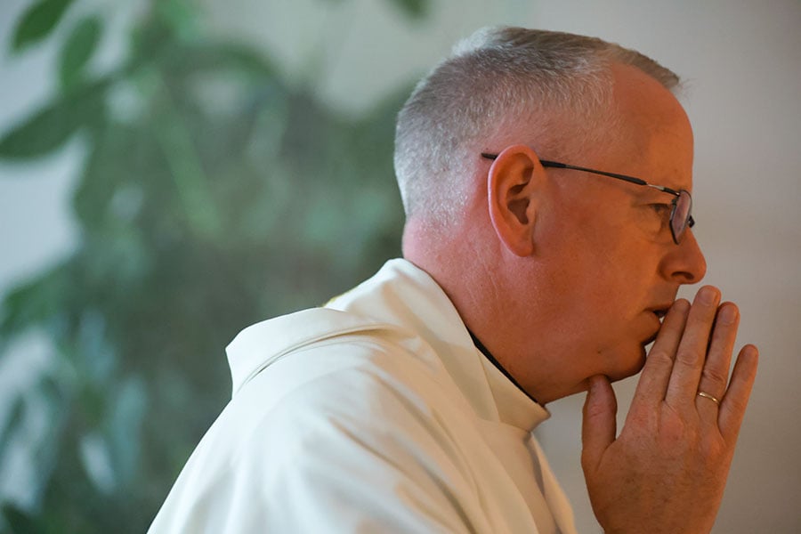 close up of Fr. O'Hara at prayer