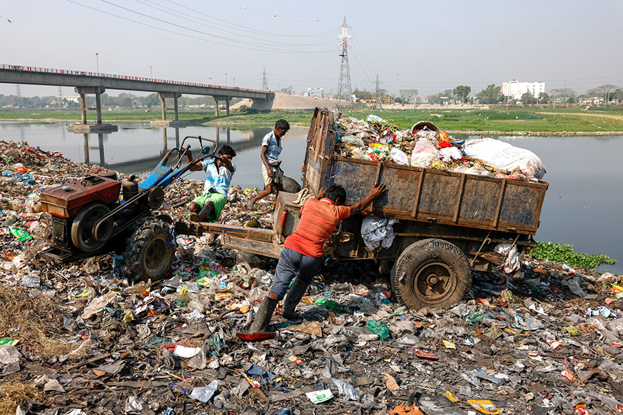 dumping trash on side of river