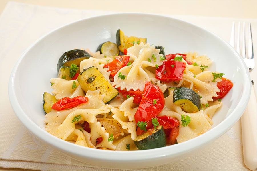 Butterfly pasta with zucchini and tomatoes