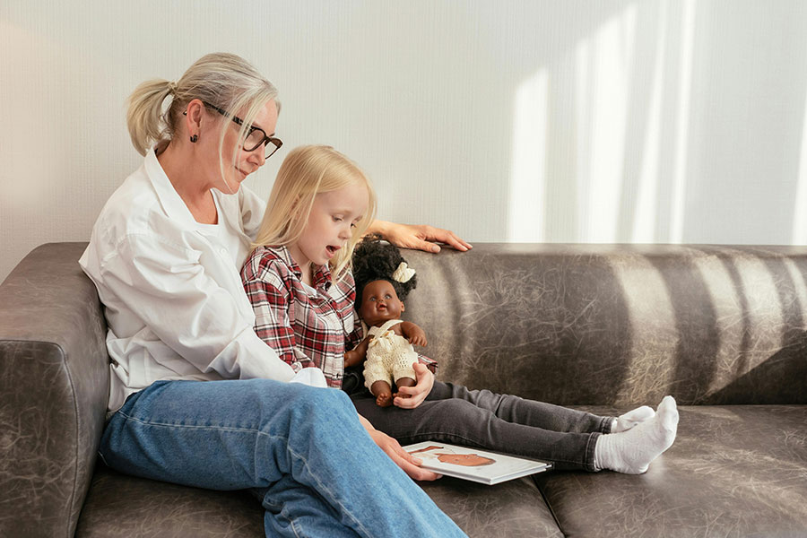 adult reading book with child