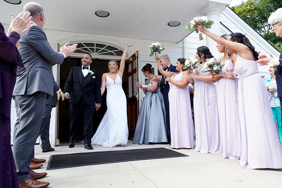 Julio Prendergast and Christina MacDougall are all smiles as they exit St. John the Baptist Church in Wading River, N.Y., following their wedding Mass Aug. 20, 2021. The theme in 2022 for National Marriage Week, celebrated annually Feb. 7-14, is "Called to the Joy of Love." World Marriage Day, observed on the second Sunday of February, is Feb. 13 this year.