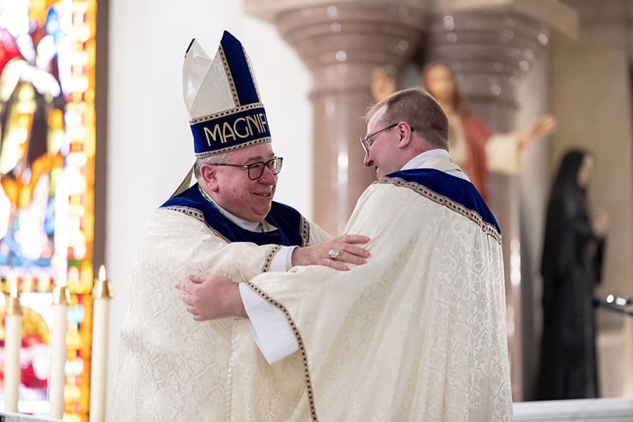 Bishop Olson greets Fr. Isaac McCracken
