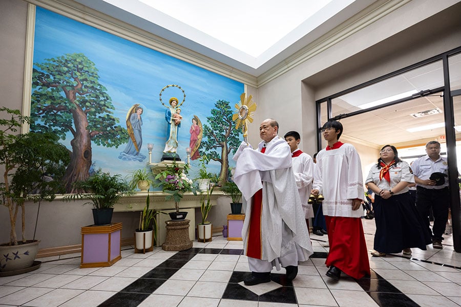Fr. Vu walks with monstrance