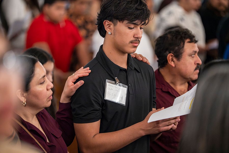 a young man stands at the Rite of Election