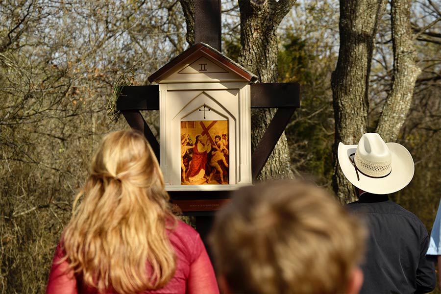A group of parishioners visit the Stations of the Cross built by Sarah and Joseph Ehlen in the woods near Saint Jo.