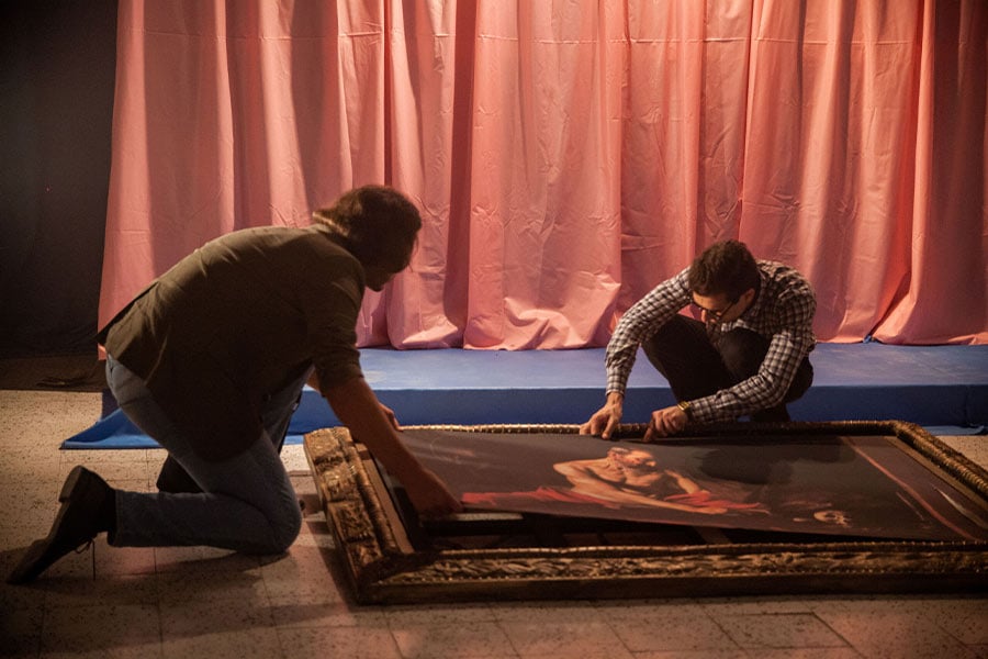 Depiction of thieves cutting Caravaggio masterpiece from its frame in “The Caravaggio Heist.” (Photo by Kayleigh Grech, courtesy PBS)