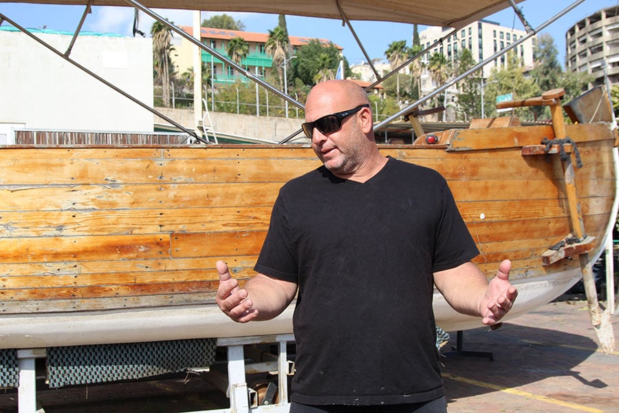 man in front of a boat