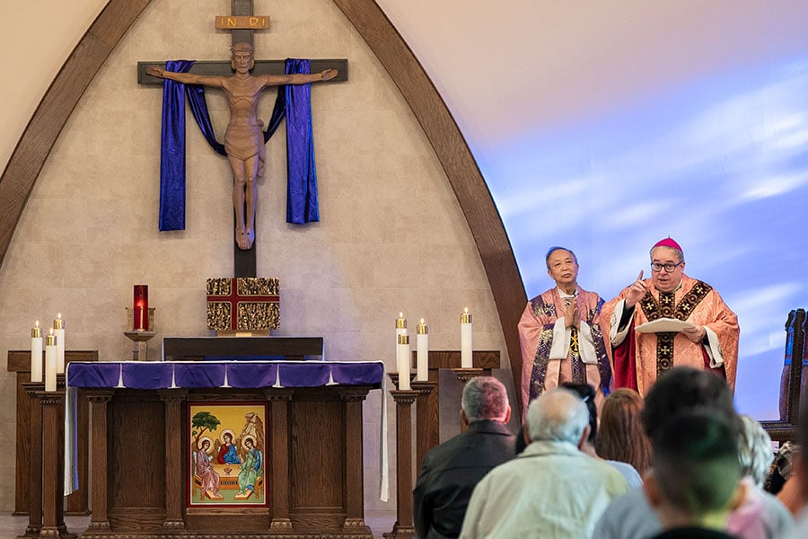 Father Thu Nguyen and Bishop Michael Olson at the altar at St. Paul the Apostle Church