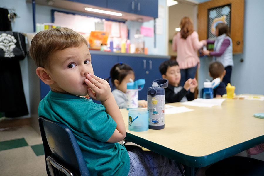 Peter Kaplonski enjoys snack time with the other two-year-olds at St. Catherine of Siena preschool in Carrollton on Thursday, Jan. 13, 2022.
