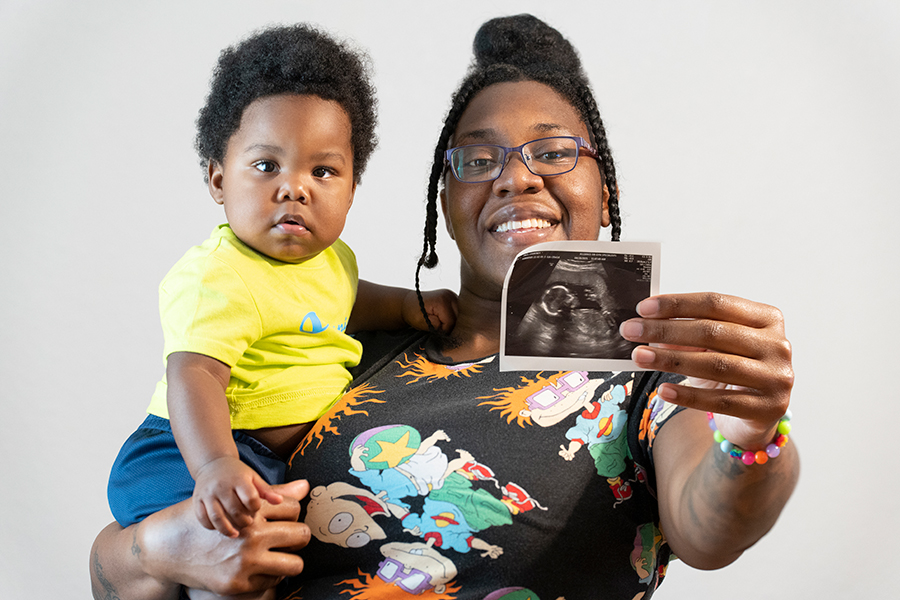 woman with baby and sonogram photo