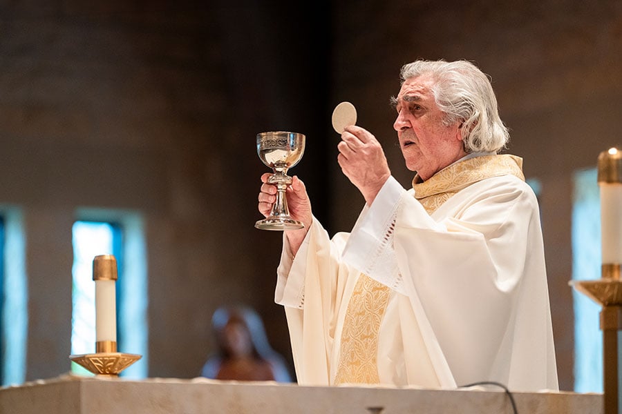 Monsignor Publius elevates the Eucharist