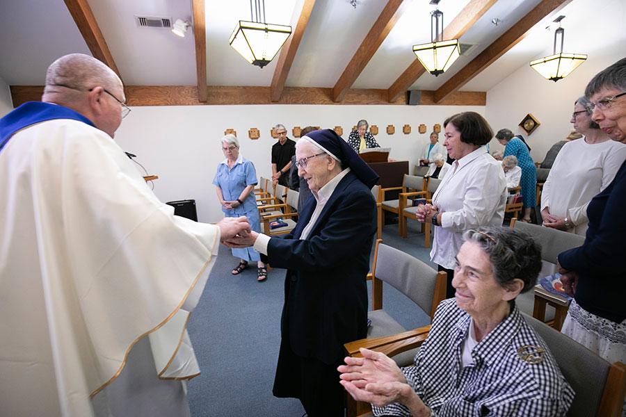 Father Shanahan distributes Communion