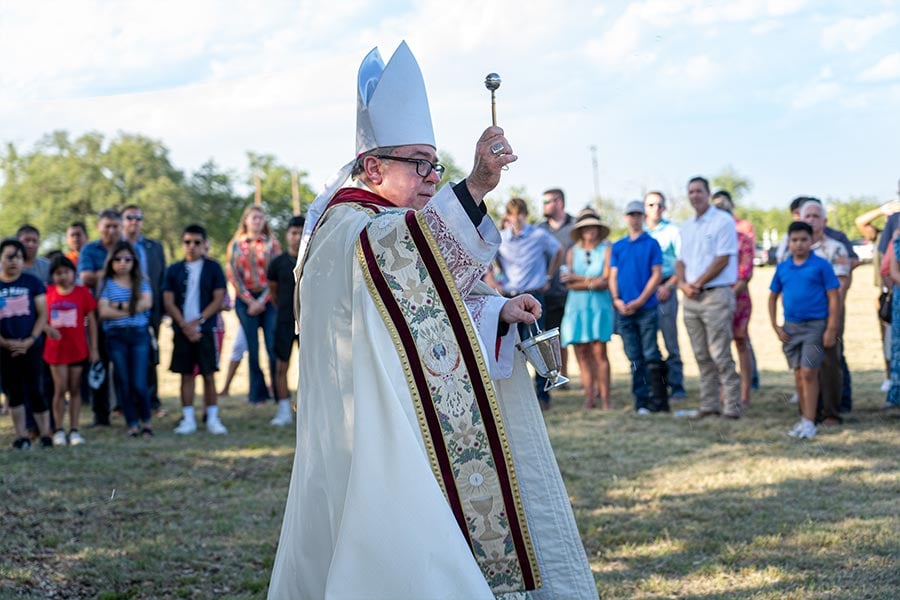 Bishop Michael Olson blesses the site of the new church for Sacred Heart Parish in Comanche. (NTC/Annette Mendoza-Smith)