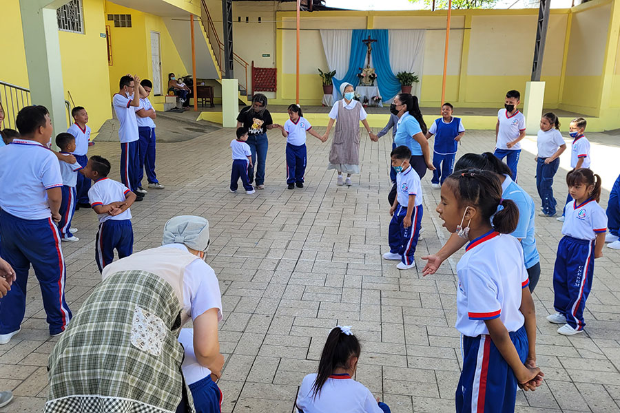 Kids and sisters stand in a circle for recreation