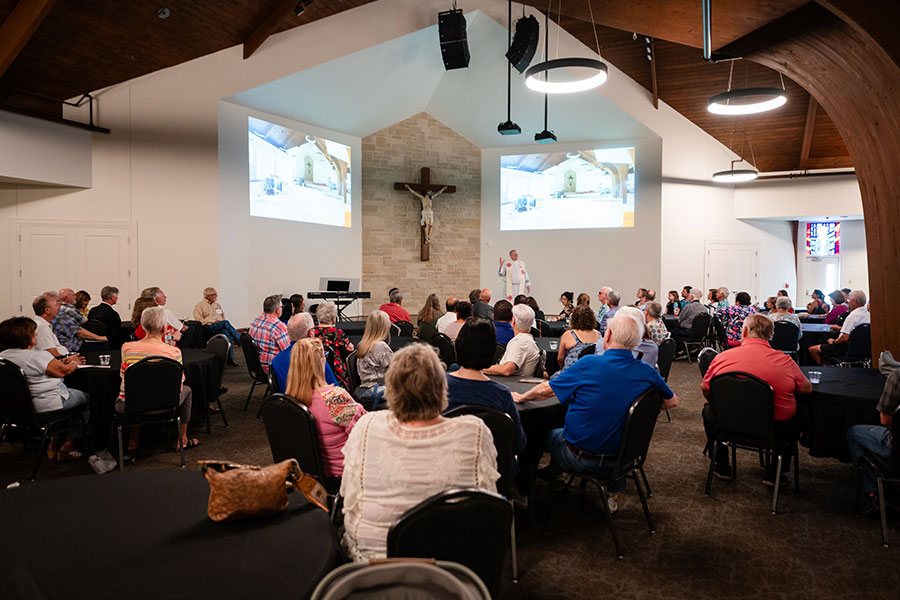 parishioners listen in the new parish hall