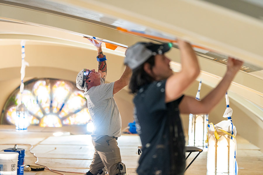 men painting ceiling