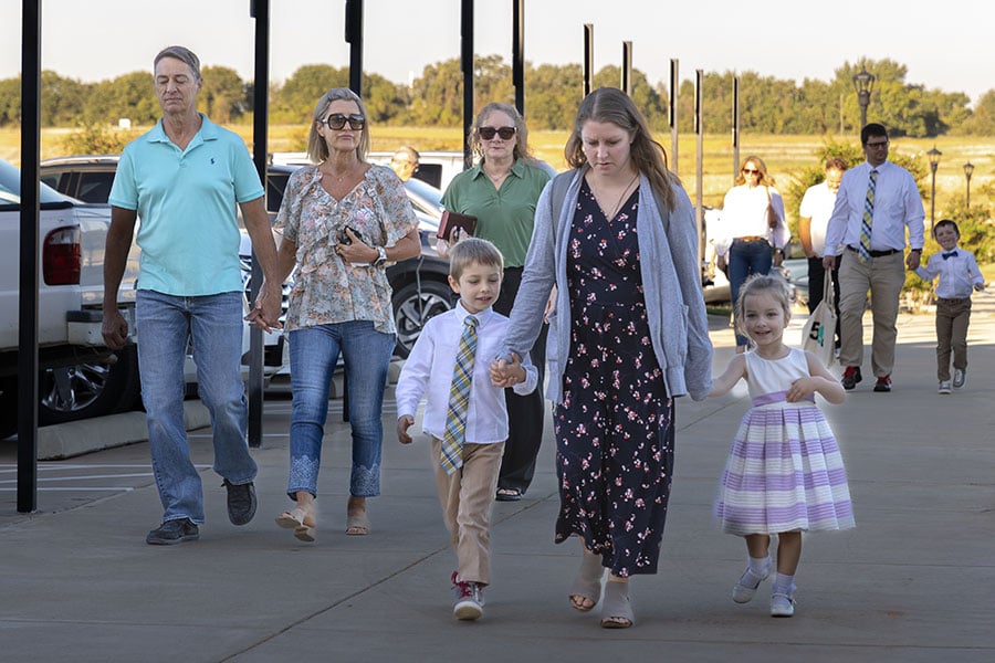 people walking into church