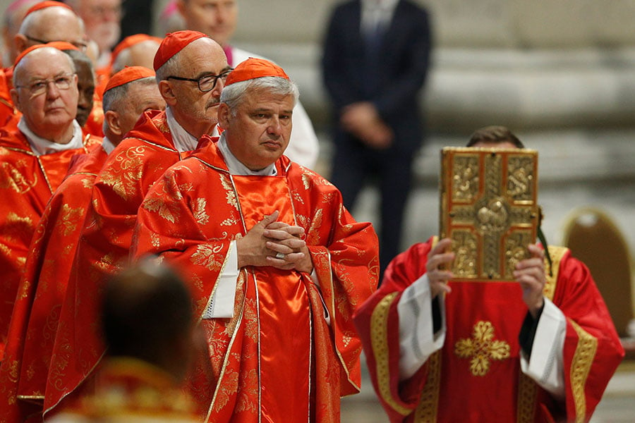 cardinals carrying gospels