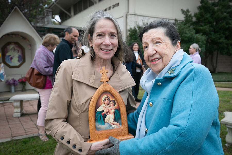 Schoenstatt Pilgrim Mother Movement members Susan Ortega and Maria Elva Garcia transfer a travelling shrine at St. Francis of Assisi in Grapevine.