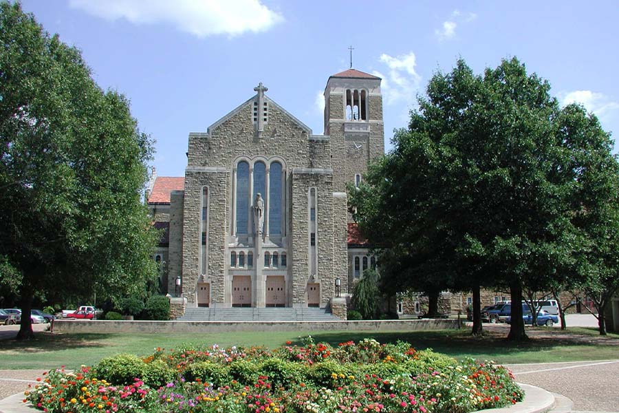 A Romanesque-style church stands at center on the grounds of Subiaco Abbey in northwestern Arkansas. Founded in 1878 the abbey includes a retreat, college-prep academy, an arts center and farmland on a sprawling campus set between the Arkansas River and Mount Magazine. (CNS photo from Arkansas Catholic)