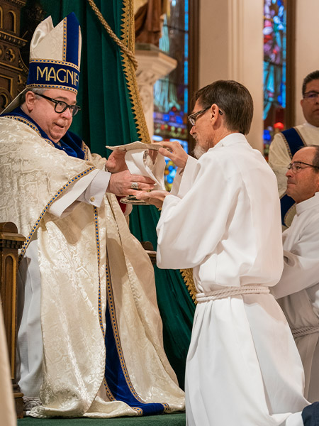 David Kinch holds a chalice and paten as he receives the Ministry of Acolyte from Bishop Michael Olson during a Mass on Nov. 6, 2021 at St. Patrick Cathedral. Kinch is a diaconal candidate in the Class of 2022. (NTC/Juan Guajardo)