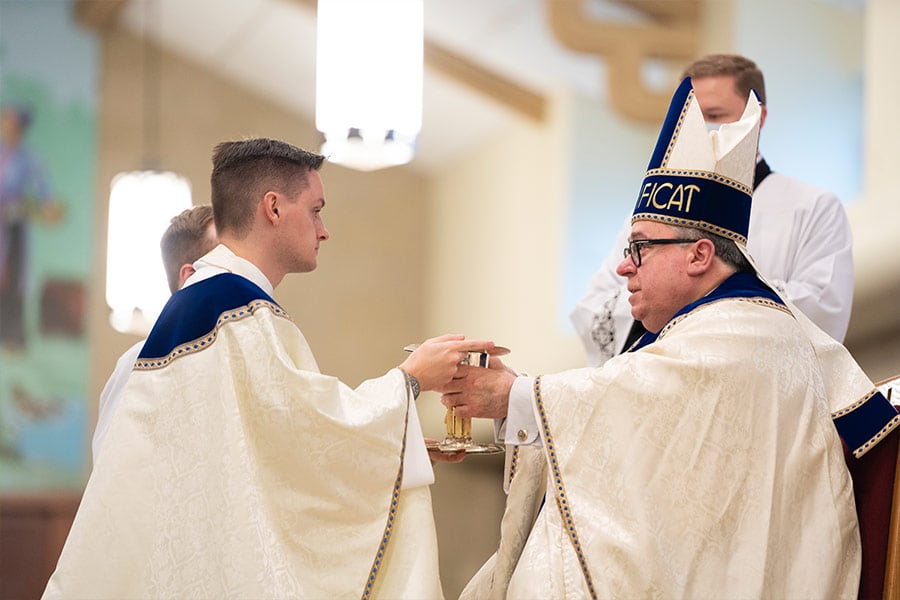Bishop Michael Olson presents a chalice and paten to Fr. Jason Allan. (NTC/Jayme Donahue)
