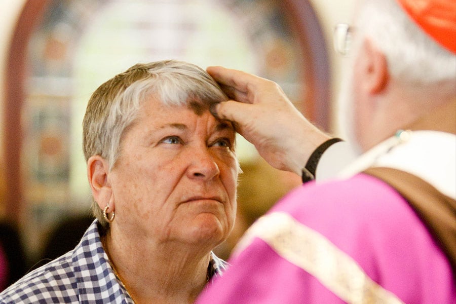 Ann Cussen of the Archdiocese of Boston's Office of Spiritual Life receives ashes