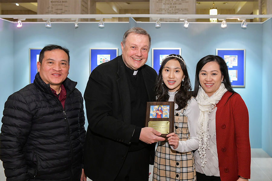 Kaylie Nguyen holds her award with father Kieran Harrington and her family. (Photo courtesy of the Nguyen Family)