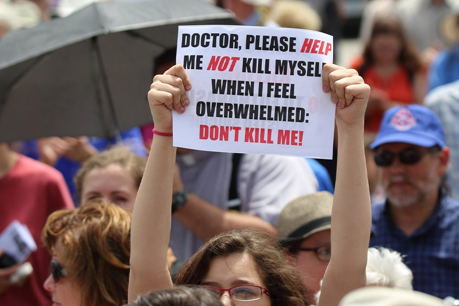 A woman is pictured in a file photo holding a sign during a rally against physician-assisted suicide on Parliament Hill in Ottawa, Ontario. Canadian bishops have urged political leaders to reconsider changes in a bill that would expand physician-assisted suicide. (CNS photo/Art Babych)