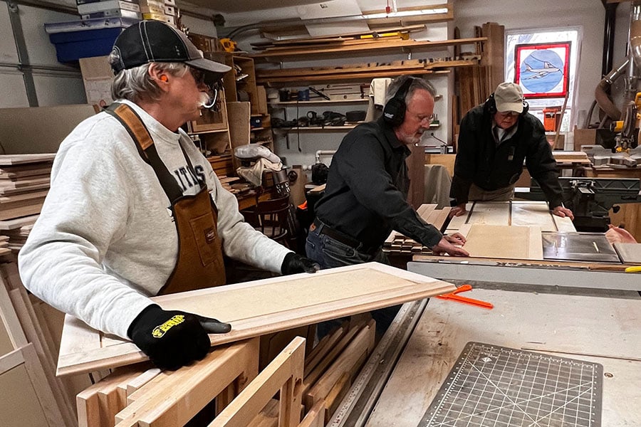 men measuring wood