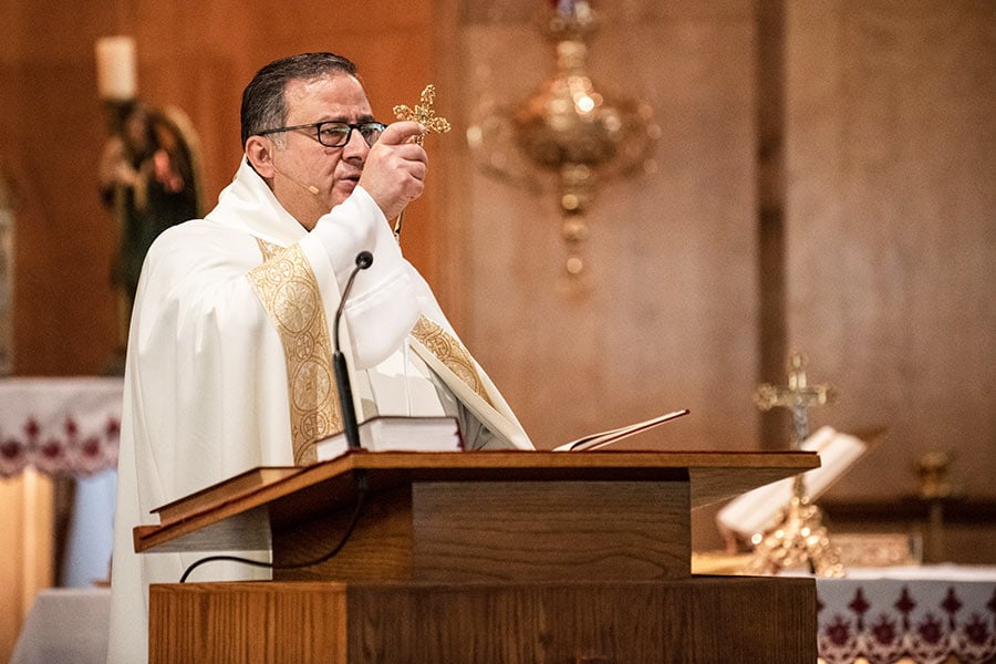 Fr. Assaad ElBasha gives a blessing during Sunday Mass.