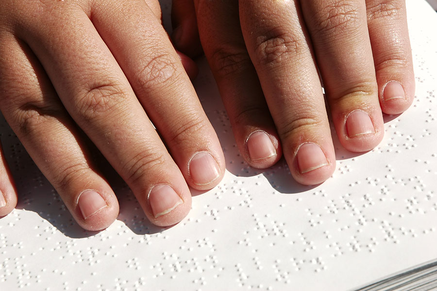 hands on a braille book